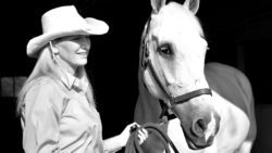 a cowgirl and her white horse