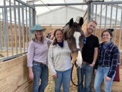 teacher, student and grads pictured with a show horse